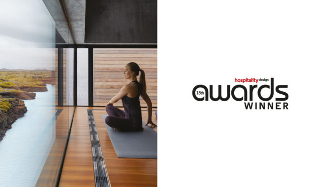 woman doing yoga next to hospitality design award logo